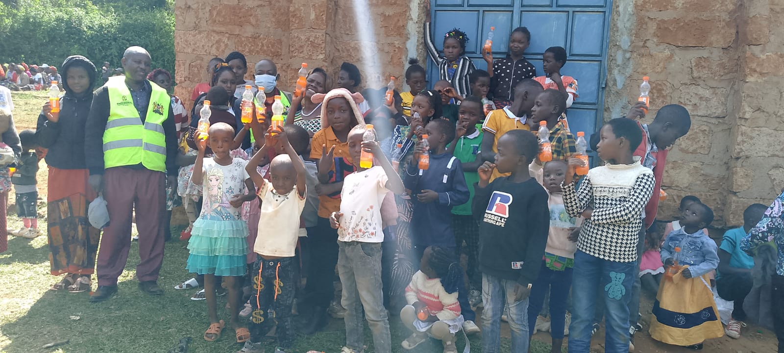 Children receiving refreshments during an outreach event