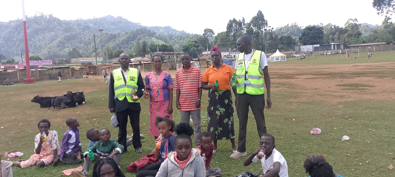 NICC volunteers with community members at the field